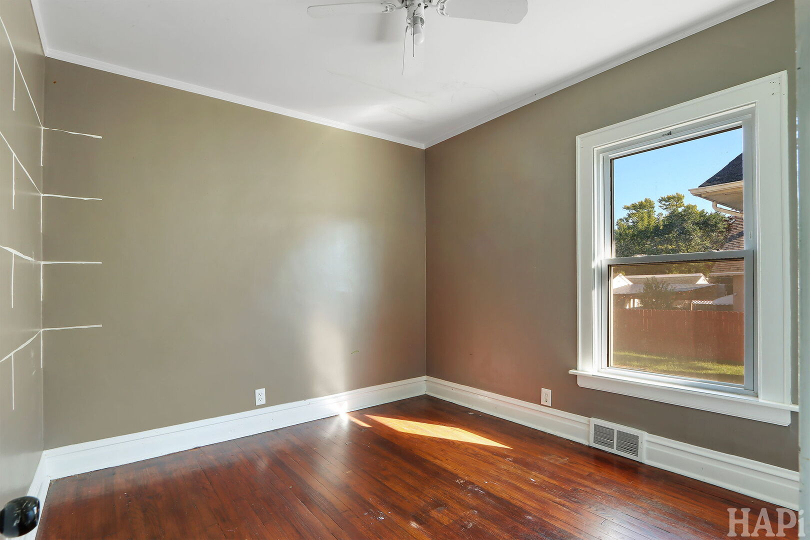 619 North Butrick Street Waukegan, IL 60085 - Photo 9 of 20 a view of an empty room with window and wooden floor