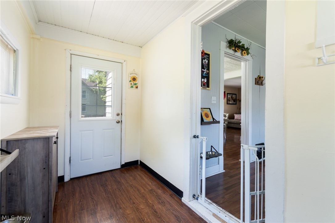 1690 Salt Springs Road Mineral Ridge, OH 44440 - Photo 3 of 21 Doorway to outside featuring ornamental molding and dark hardwood / wood-style floors