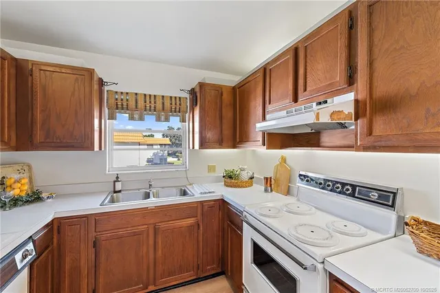 a kitchen with a sink stove and cabinets