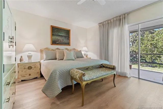 a bedroom with a bed and large window