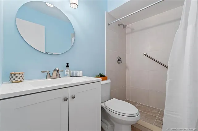 a bathroom with a sink toilet and a mirror