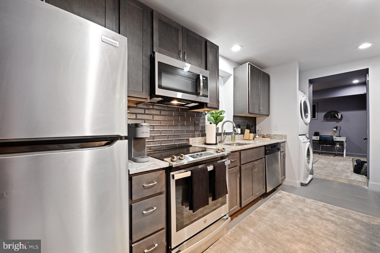 1709 Bank Street Baltimore, MD 21231 - Photo 30 of 49 a kitchen with stainless steel appliances a refrigerator sink and microwave