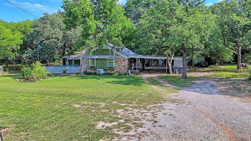 140 Elm Road Nocona, TX 76255 - Photo 23 of 26 a view of a house with a yard porch and sitting area