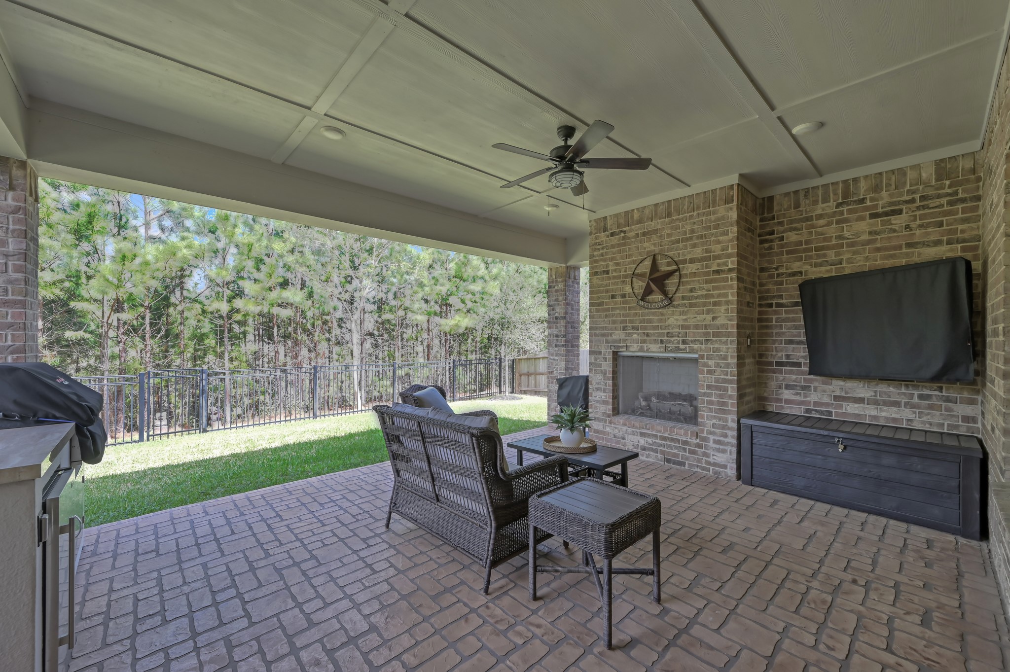 334 Torrey Bloom Loop Conroe, TX 77304 - Photo 6 of 47 Covered brick patio with wood burning fireplace on a premium reserve lot!