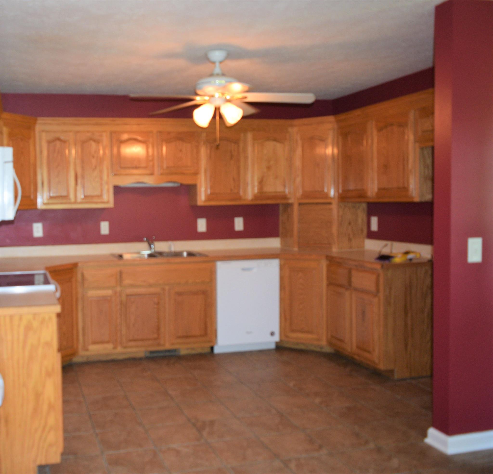4893 Albright Road Clarksville, TN 37043 - Photo 10 of 20 Oak cabinets, tile floors and ceiling fan in the spacious kitchen.