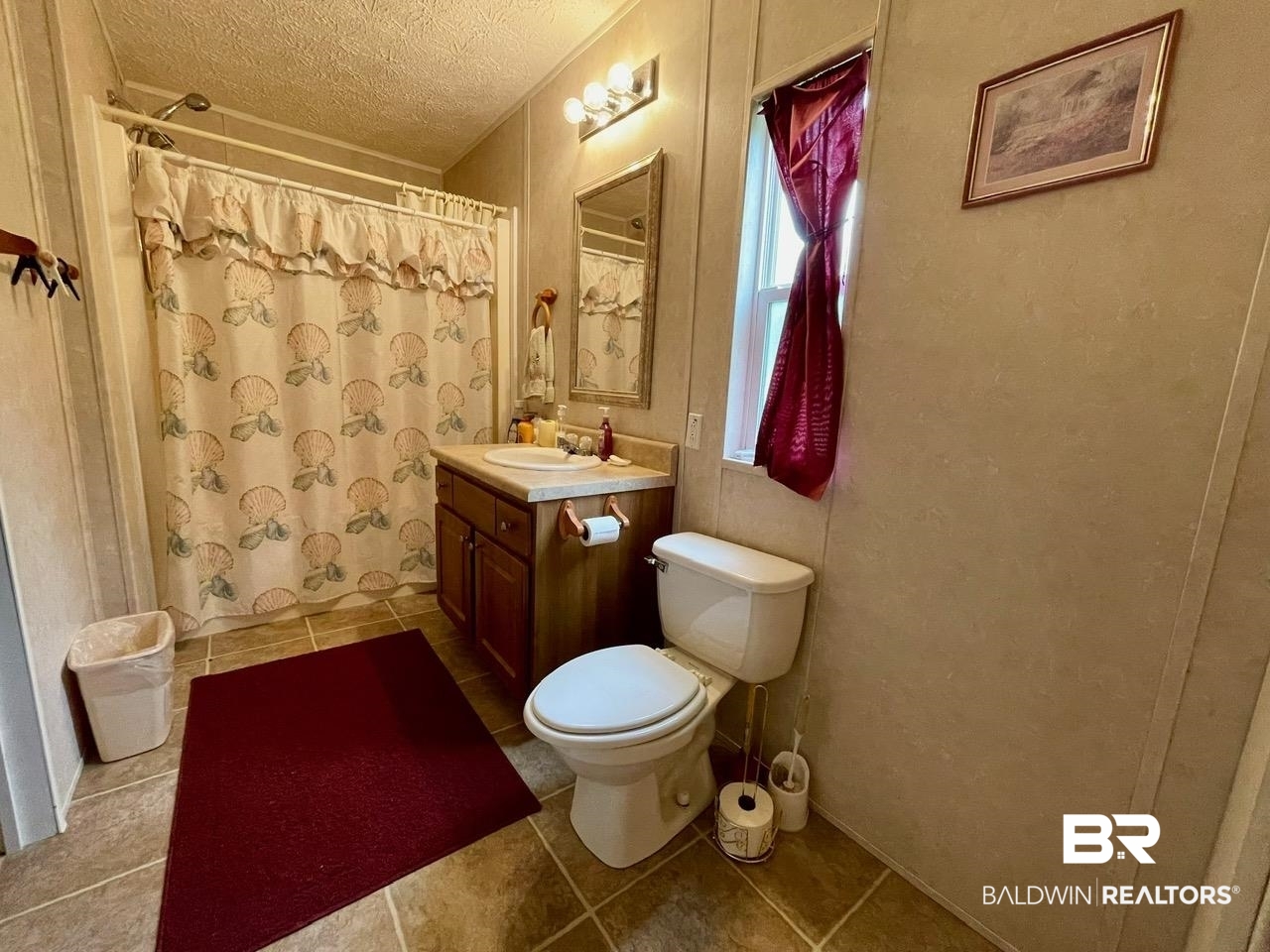 15338 Windbigler Drive Foley, AL 36535 - Photo 18 of 28 Bathroom with toilet, tile patterned floors, vanity, a textured ceiling, and curtained shower