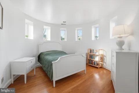 a bedroom with a bed and a chair
