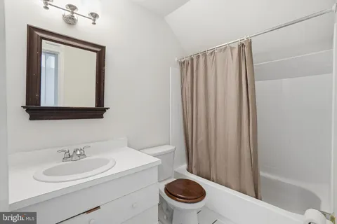 a bathroom with a toilet a sink and a mirror
