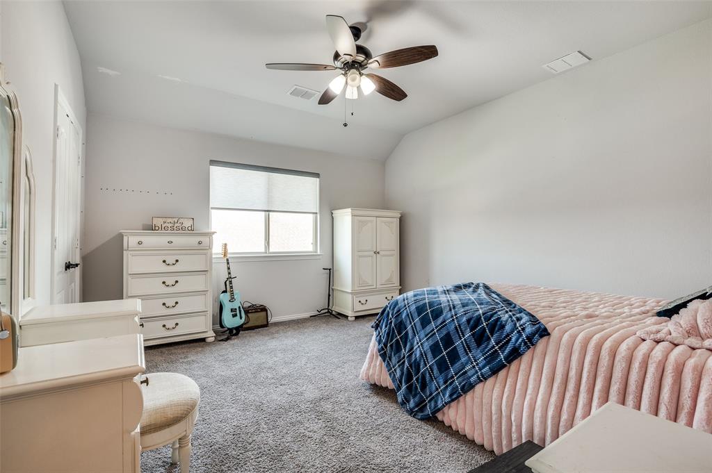 4609 Massey Meadows Way Midlothian, TX 76065 - Photo 18 of 25 a bedroom with a bed and a chandelier