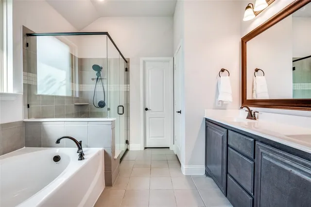 a bathroom with a tub sink and mirror