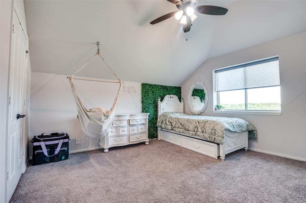 4609 Massey Meadows Way Midlothian, TX 76065 - Photo 20 of 25 a bedroom with a bed and a chandelier