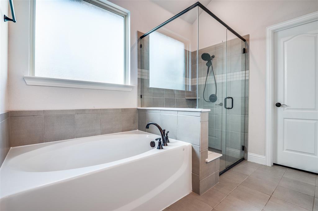 4609 Massey Meadows Way Midlothian, TX 76065 - Photo 21 of 25 a bathroom with a bathtub and a shower
