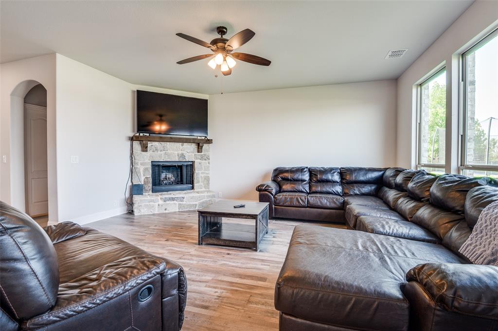 4609 Massey Meadows Way Midlothian, TX 76065 - Photo 5 of 25 a living room with furniture a flat screen tv and a fireplace