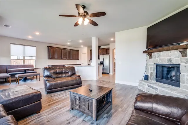 a living room with furniture a flat screen tv and a fireplace