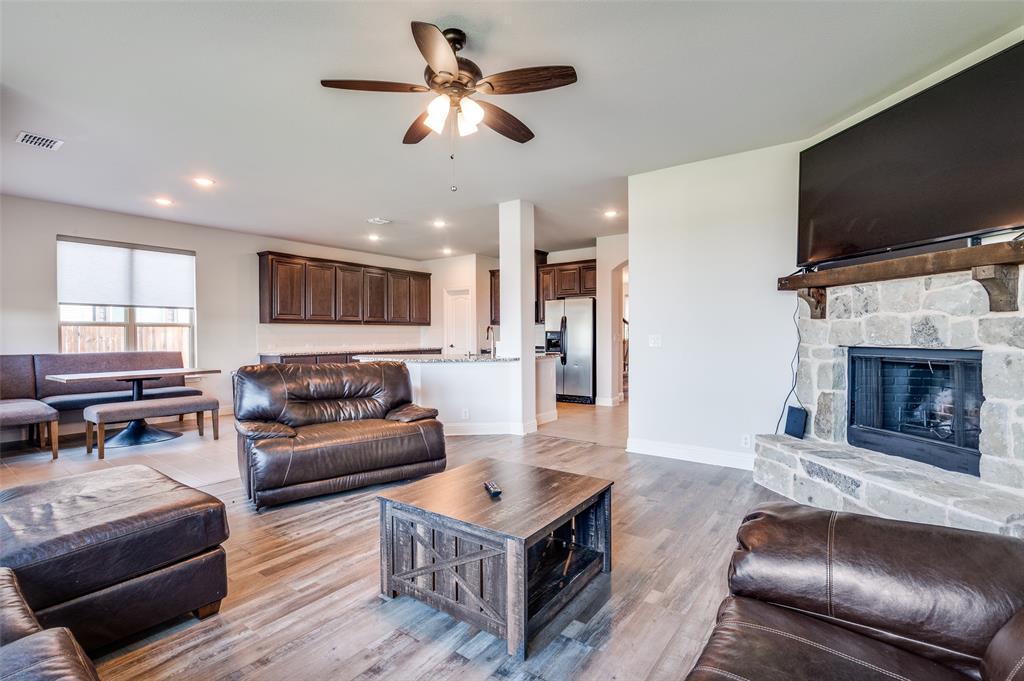 4609 Massey Meadows Way Midlothian, TX 76065 - Photo 6 of 25 a living room with furniture a flat screen tv and a fireplace