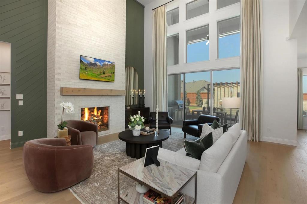 317 Bee Balm Road McKinney, TX 75071 - Photo 4 of 24 a living room with furniture and a fireplace