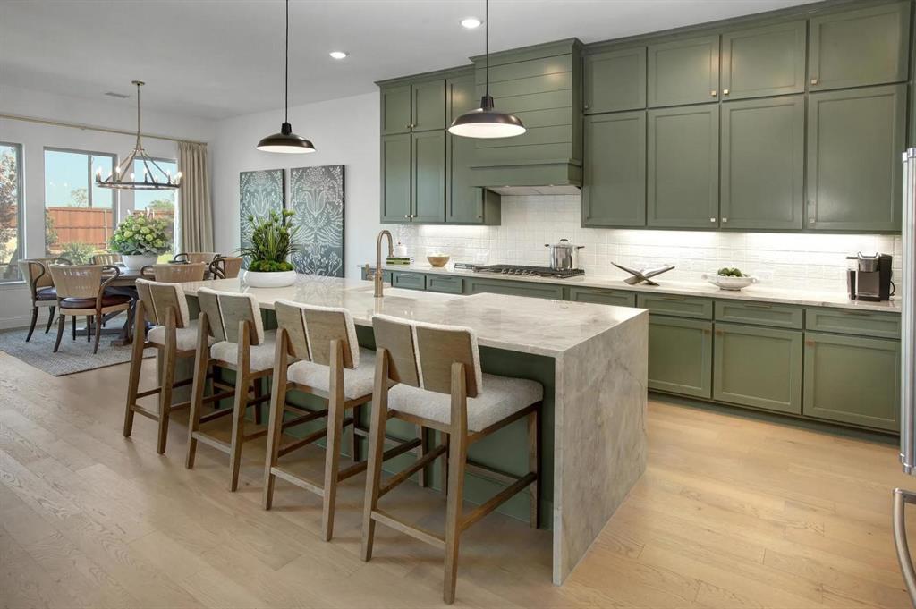 317 Bee Balm Road McKinney, TX 75071 - Photo 8 of 24 a large kitchen with a table and chairs