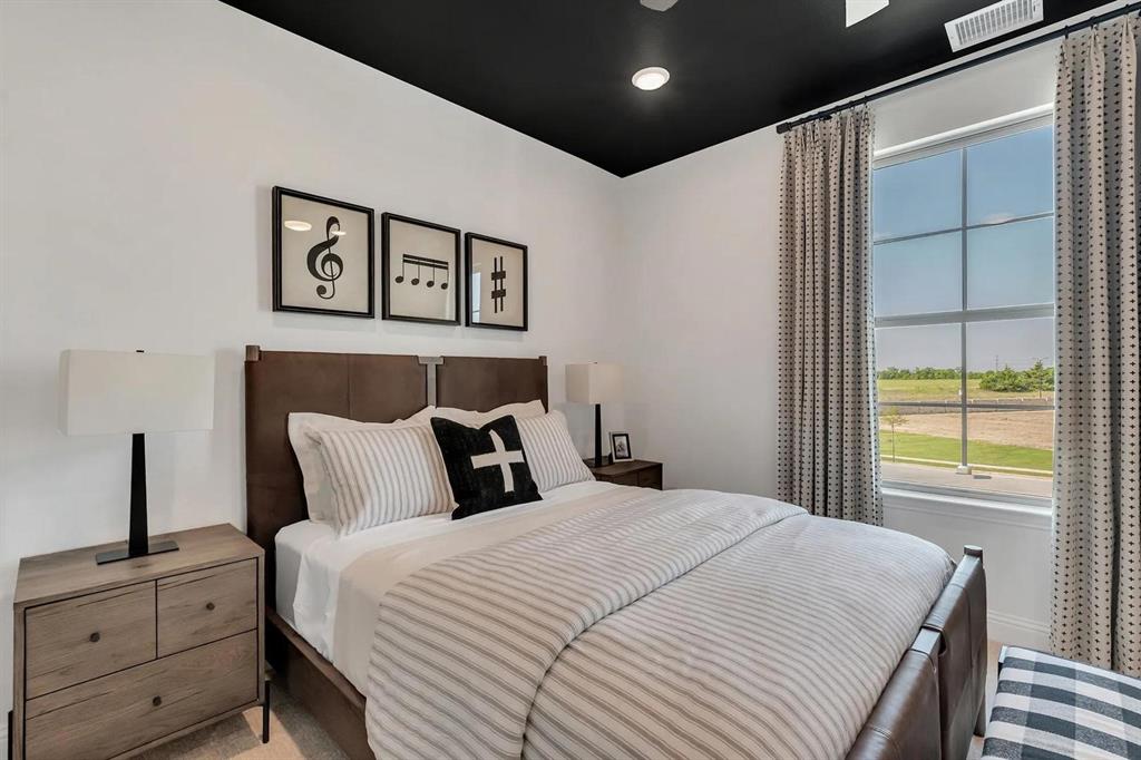 317 Bee Balm Road McKinney, TX 75071 - Photo 10 of 24 a bedroom with a large bed and a window
