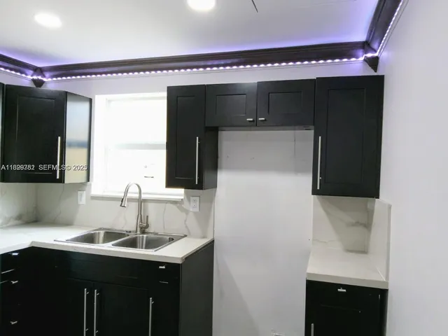 a kitchen with a sink and cabinets