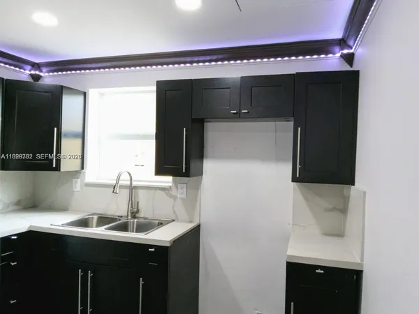 a kitchen with a sink and cabinets