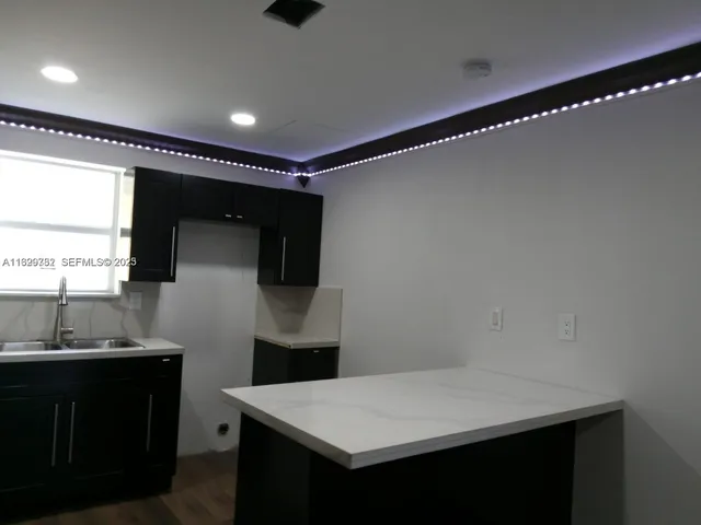 a kitchen with a sink and a refrigerator
