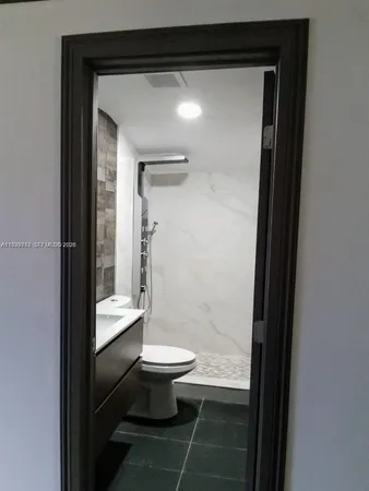 a bathroom with a toilet and a shower