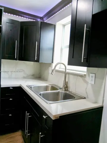 a kitchen with a sink and cabinets