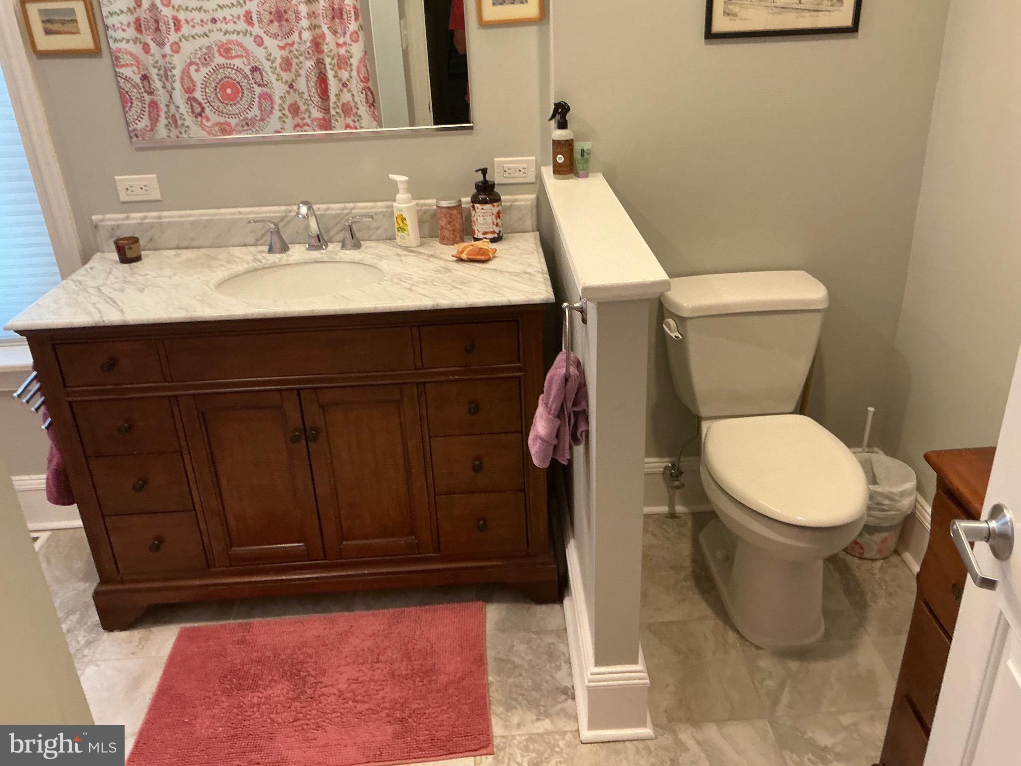 29 Centre Street Haddonfield, NJ 08033 - Photo 27 of 39 a bathroom with a toilet sink and mirror