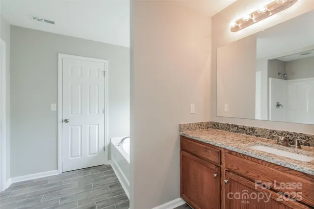 a view of bathroom with granite countertop sink and vanity