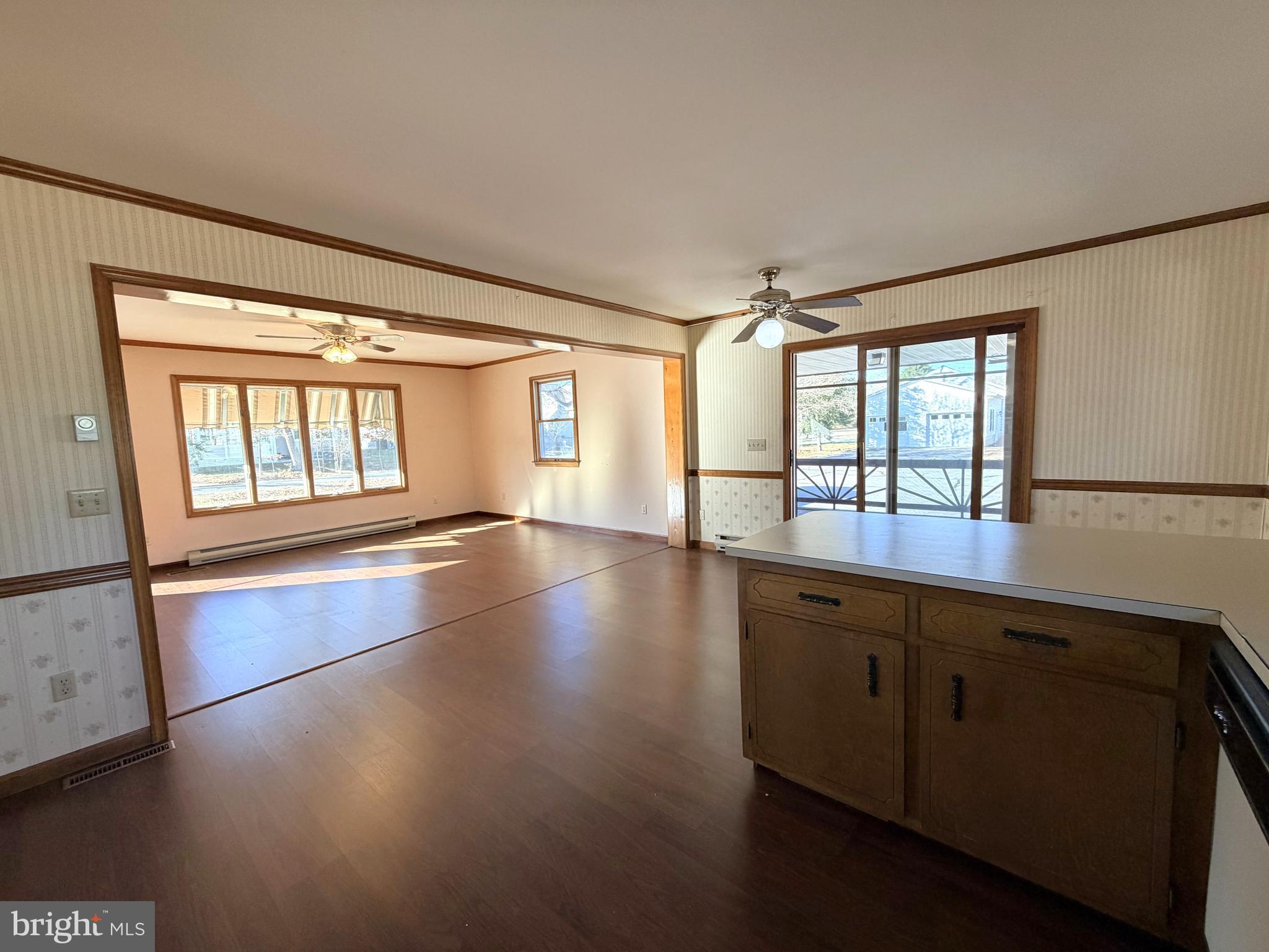 31461 Hope Street Ocean View, DE 19970 - Photo 11 of 20 an empty room with wooden floor and windows