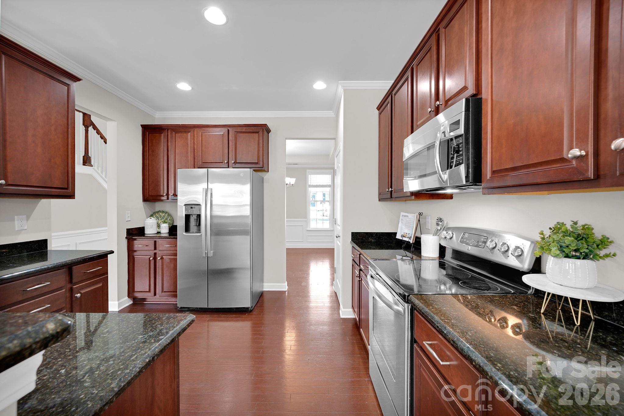 5072 Gladiola Way Tega Cay, SC 29708 - Photo 11 of 40 a kitchen with stainless steel appliances granite countertop a refrigerator a stove top oven a sink and dishwasher