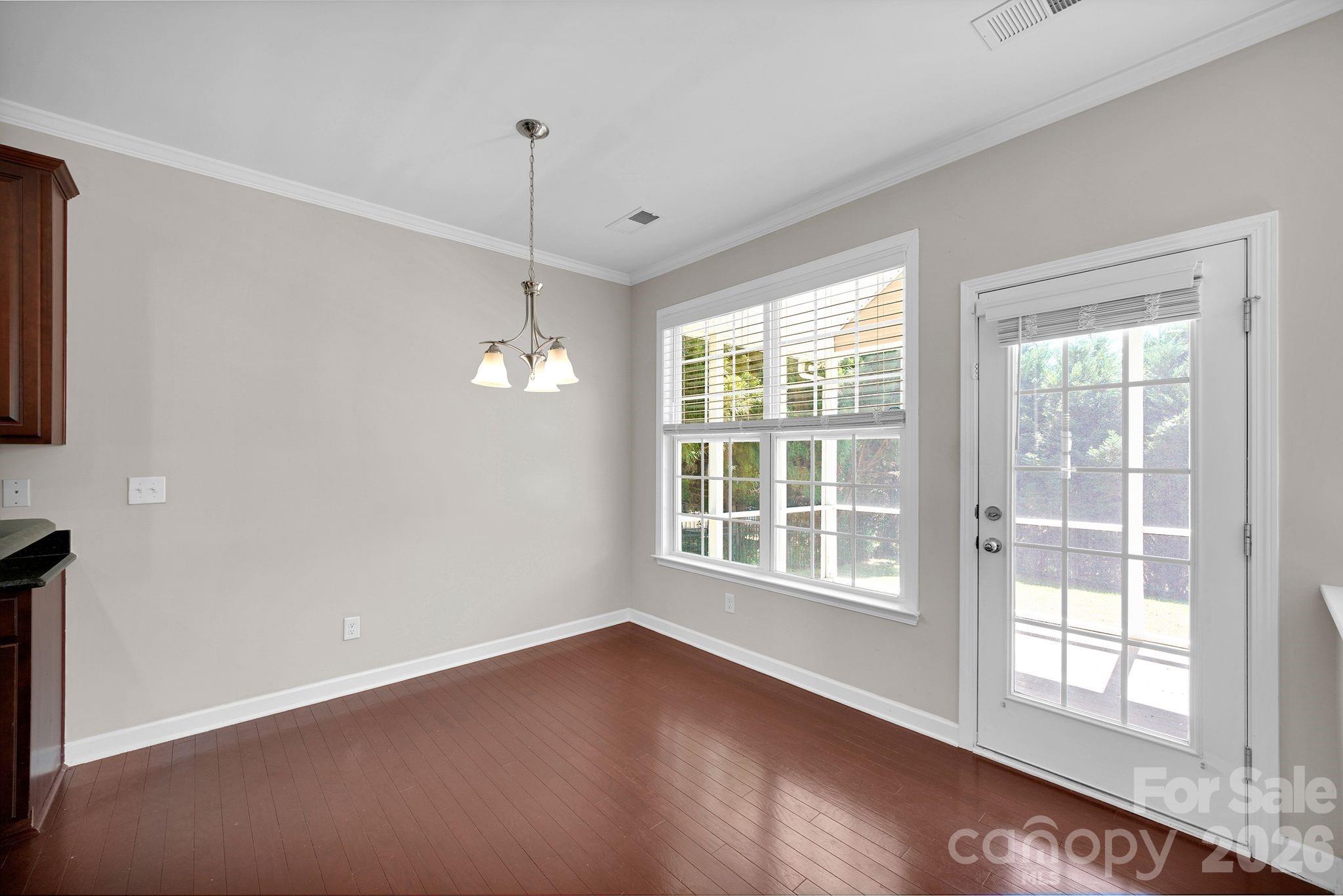 5072 Gladiola Way Tega Cay, SC 29708 - Photo 12 of 40 an empty room with wooden floor and windows