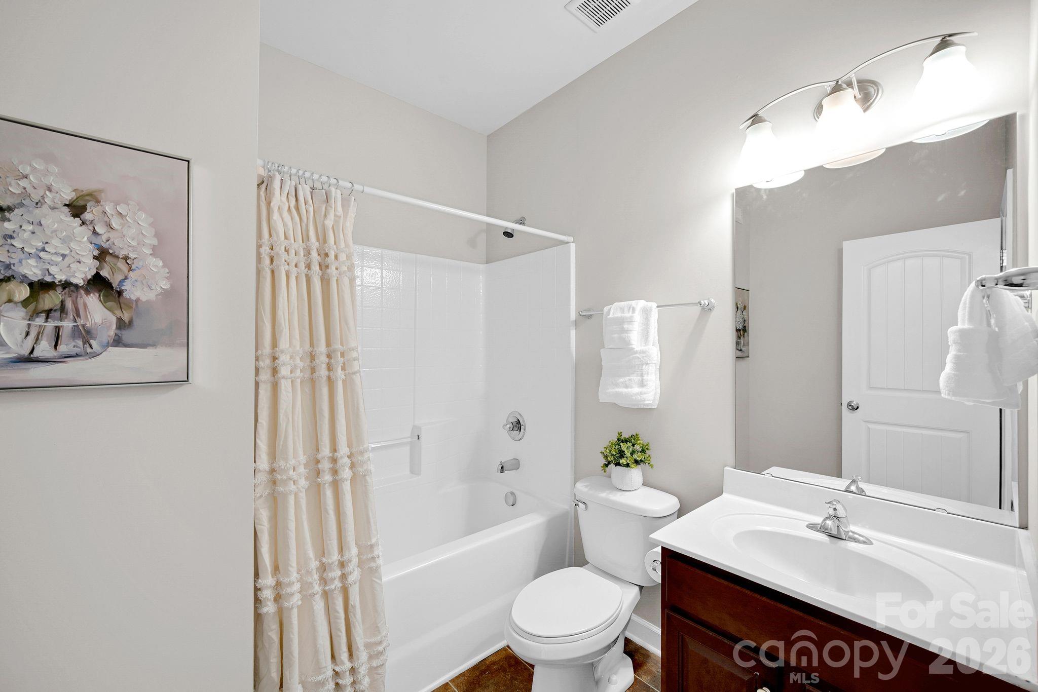 5072 Gladiola Way Tega Cay, SC 29708 - Photo 17 of 40 a bathroom with a sink a toilet and bathtub