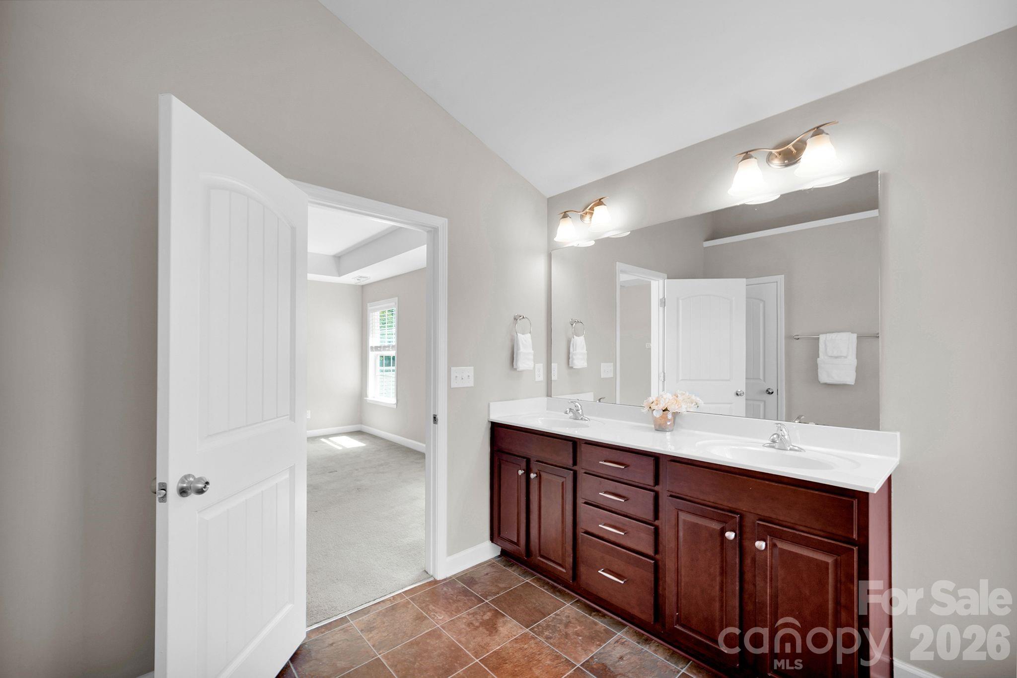 5072 Gladiola Way Tega Cay, SC 29708 - Photo 24 of 40 a spacious bathroom with a double vanity sink and a mirror