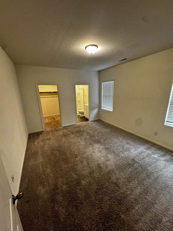 1813 Chapel Hill Road Princeton, TX 75407 - Photo 8 of 20 Carpeted flooring, two windows with blinds, flush mount ceiling light fixture, and two doorways