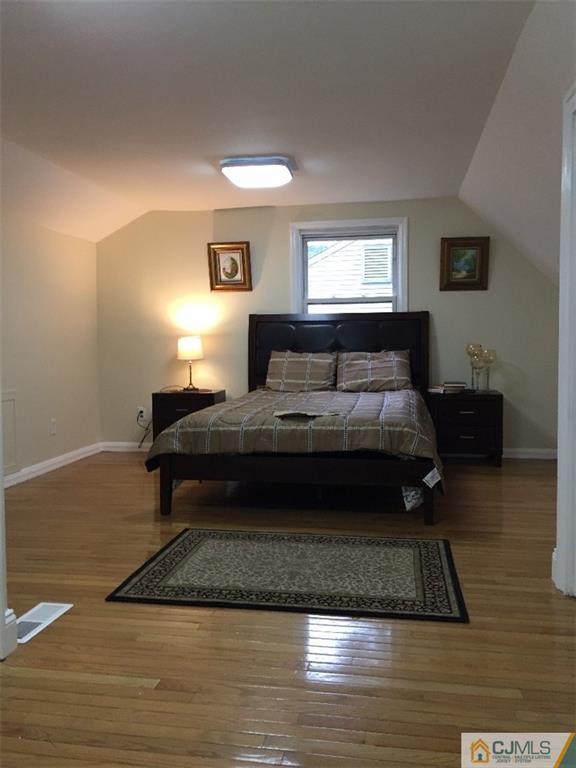 21 Meyer Road Edison, NJ 08817 - Photo 14 of 25 a bedroom with a bed rug and wooden floor