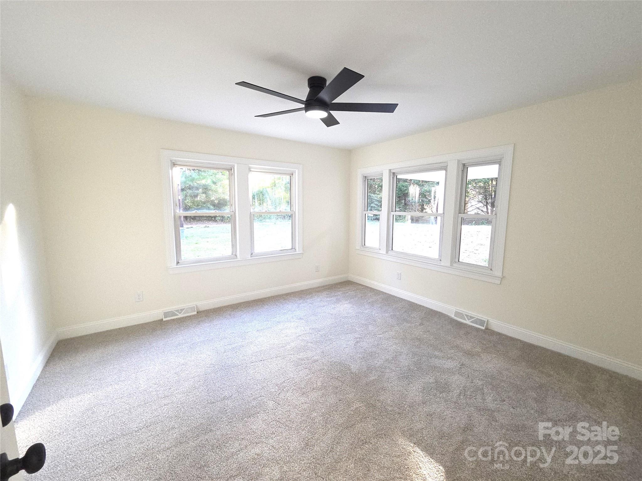 4750 J W Cline Road Kannapolis, NC 28083 - Photo 13 of 16 an empty room with windows and ceiling fan
