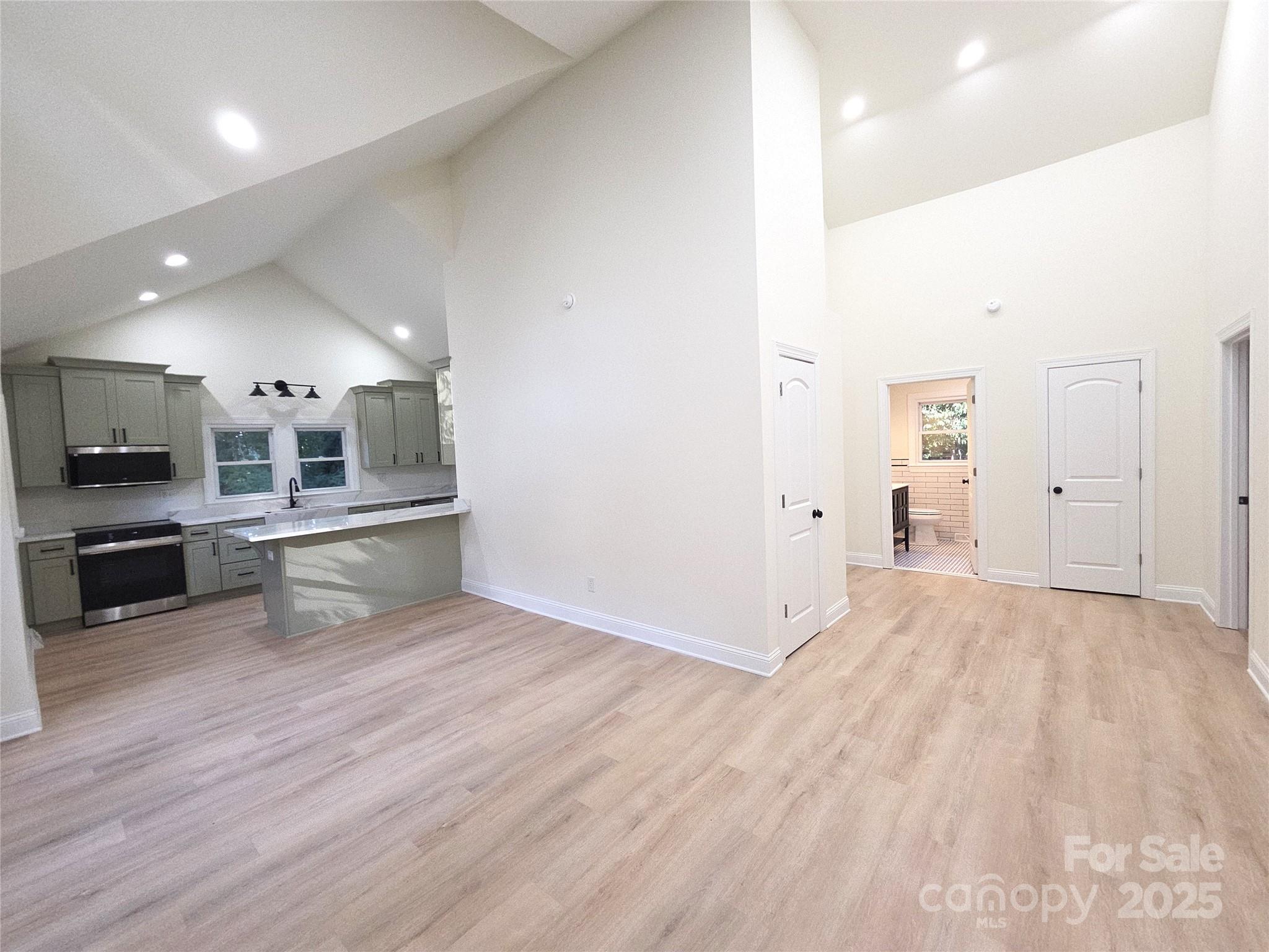 4750 J W Cline Road Kannapolis, NC 28083 - Photo 3 of 16 an empty room with wooden floor and windows