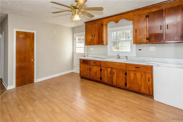 a view of a kitchen with a sink cabinet and a window