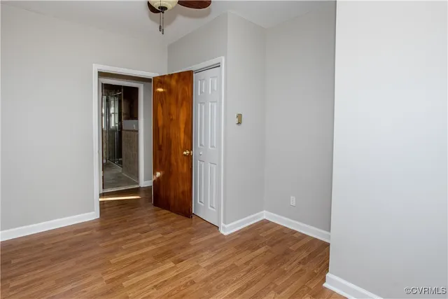 a view of empty room with wooden floor