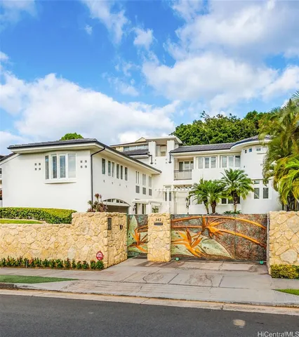 a view of a house with a swimming pool and sitting area
