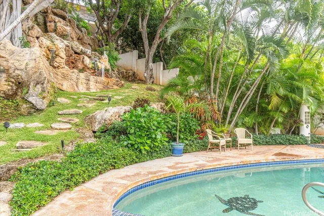 a view of a pool with a yard