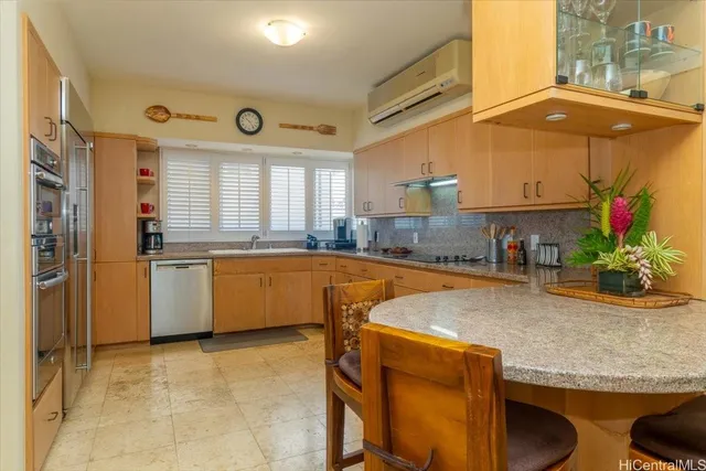 a kitchen with granite countertop a sink and a stove