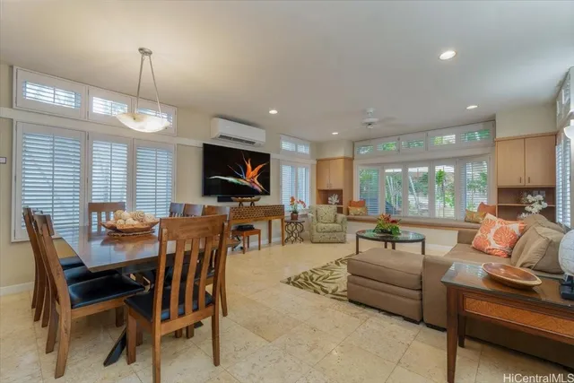 a living room with furniture a flat screen tv and a large window