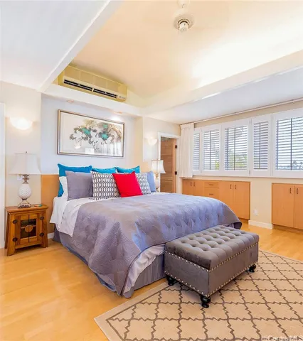 a bedroom with a bed and a view of living room