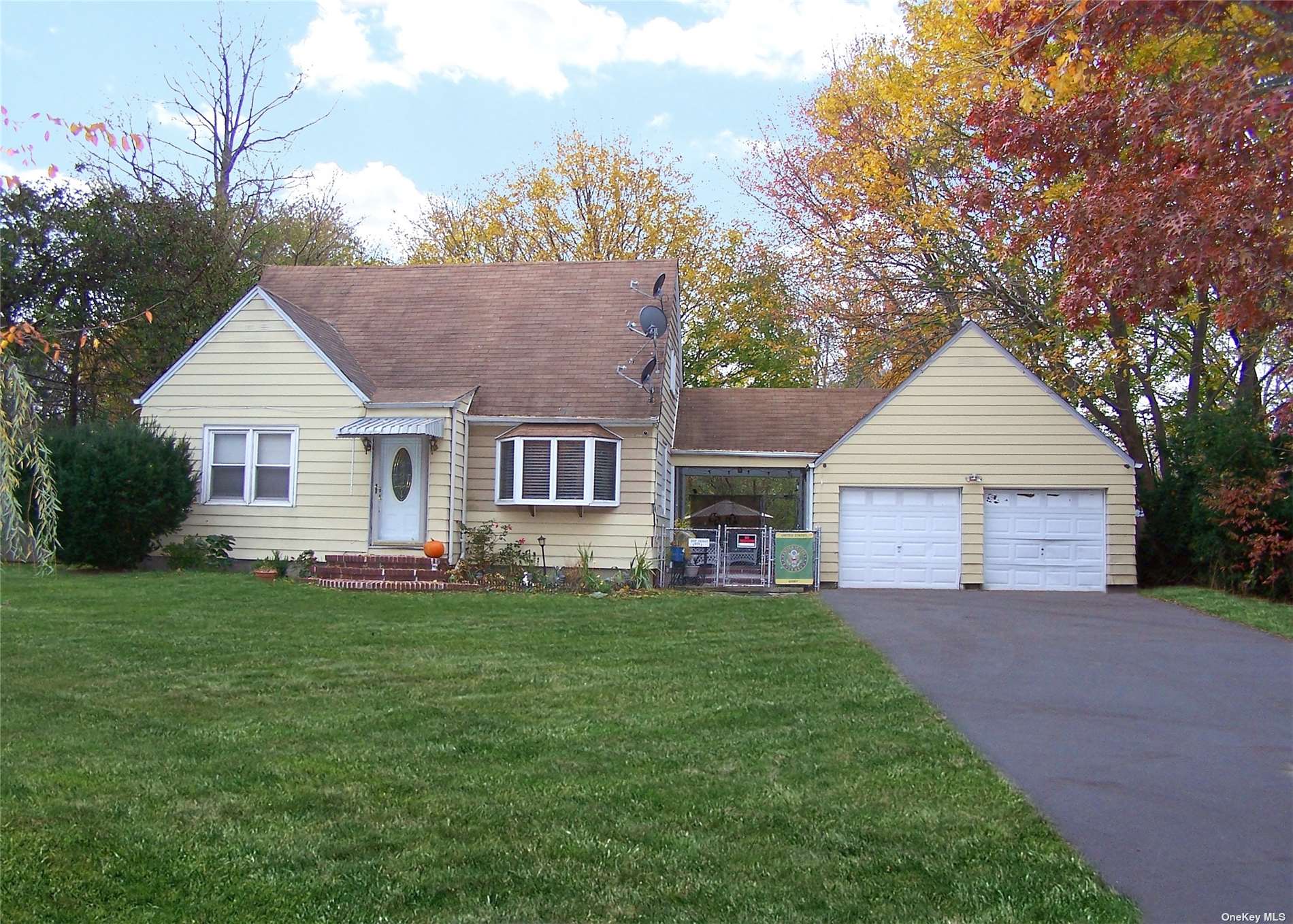 36 Dare Road Selden, NY 11784 - Photo 1 of 1 a front view of a house with a garden and yard