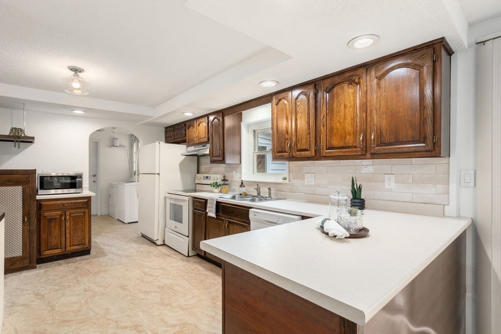 10 Temi Road Chelmsford, MA 01824 - Photo 8 of 22 a kitchen with stainless steel appliances granite countertop a sink stove and refrigerator