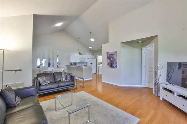 a living room with furniture and a chandelier