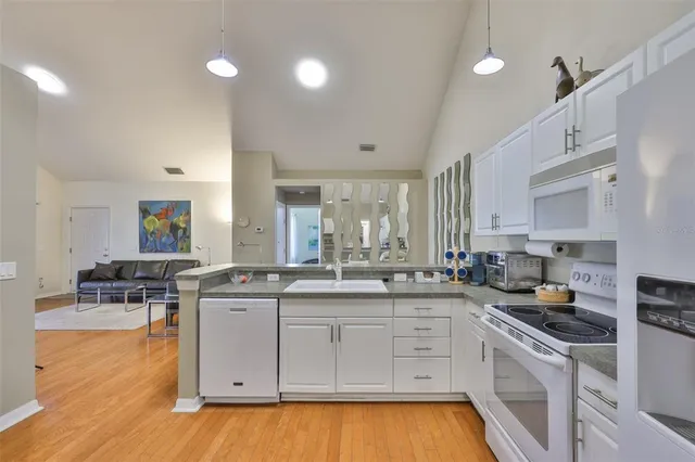 a kitchen with a sink stove and cabinets