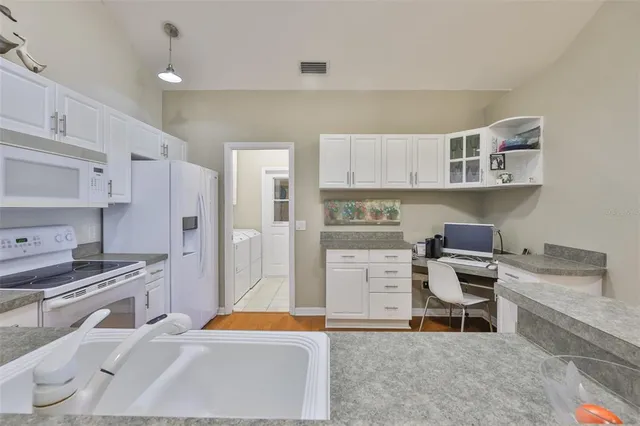 a kitchen with a sink and a stove top oven